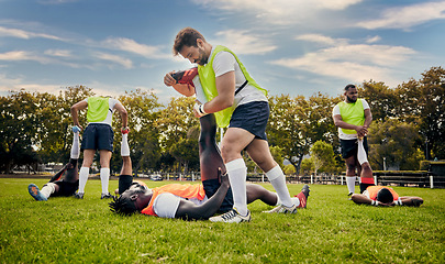 Image showing Sports, rugby and outdoor stretching legs on a grass field with a team doing warm up. Athlete men group together for fitness, exercise and workout for professional sport with coach and teamwork