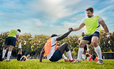 Image showing Teamwork, helping hand or rugby men in training, exercise or workout in practice match on grass field. Challenge, strong man or powerful group in tough competitive sports game with physical fitness