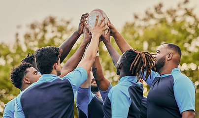 Image showing Diversity, team and men hands together in sports for support, motivation or goals outdoors. Sport group holding rugby ball in fitness, teamwork or success for match preparation or game