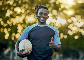 Image showing Rugby, thumbs up and portrait of black man with ball, confidence and pride in winning game. Fitness, sports and happy face of player ready for match, workout or competition at stadium in South Africa