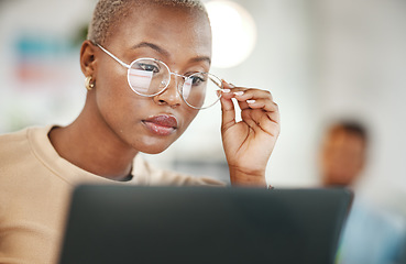 Image showing Office, computer and black woman with glasses, serious or reading email, online research or report. Laptop, concentration and African journalist proofreading article for digital news website or blog