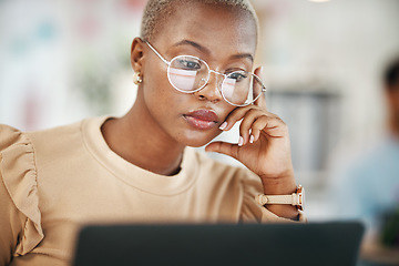 Image showing Office, laptop and black woman, serious and reading email or online research report, with glasses. Computer, concentration and African journalist proofreading article on digital news website or blog