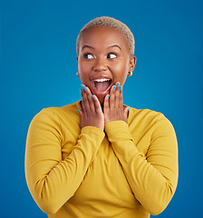 Image showing Black woman, happy and surprise face in studio for fashion, youth or notification by blue background. Young african girl, model or happiness with excited wow, announcement or deal with hands by mouth