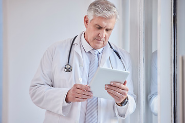 Image showing Doctor, tablet and senior man in hospital for research, telehealth or online consultation. Healthcare, technology and elderly medical professional with touch screen for wellness app in health clinic.