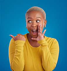 Image showing Black woman, gossip and secret in studio with hand on face for sale announcement. African female model on a blue background to whisper message, news information or wow rumor pointing at mockup deal