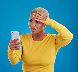 Image showing Wtf, phone and confused black woman in studio for fake news, social media and text on blue background. Omg, scam and girl with smartphone notification for phishing alert, glitch or internet problem