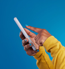 Image showing Phone, typing and hands of woman point to screen in studio for social media, text message and website. Communication, technology and girl on internet, networking and chat online on blue background