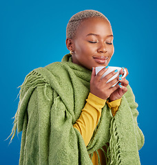 Image showing Coffee, scent and a black woman on a blue background in studio smelling the aroma for her mug. Relax, drink and easy with an attractive young female enjoying a fresh cup of caffeine during a break