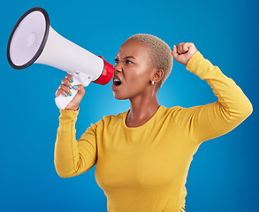 Image showing Megaphone, black woman and screaming in studio with fist of power, broadcast or vote on blue background. Speaker, microphone and girl protest for change, democracy or justice, noise or womens rights