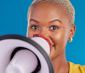 Image showing Megaphone, opinion and speaker with black woman in studio for change, democracy and protest. Vote, announcement and message with female isolated on blue background for empowerment, strike and choice