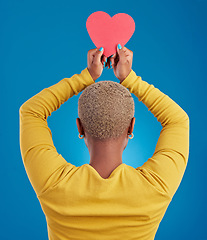 Image showing Paper, heart and back of black woman in studio for love, date and kindness. Invitation, romance and feelings with female and shape isolated on blue background for emotion, support and affectionate