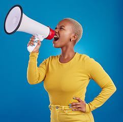 Image showing Megaphone, angry and screaming black woman in studio for message, broadcast or vote on blue background. Speaker, microphone and girl protest for change, democracy and justice, noise and womens rights