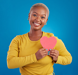 Image showing Paper heart, happy black woman and portrait in studio, blue background and backdrop. Smile, female model and shape for love, wellness and support of peace, thank you and kindness on valentines day