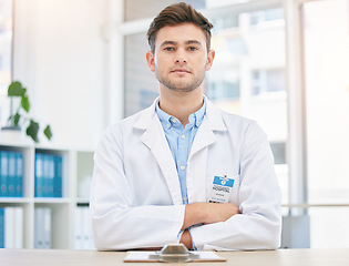 Image showing Medical, serious and portrait of assertive doctor man in a hospital office feeling confident, focus and proud in clinic. Young medicine expert and healthcare professional with arms crossed for health