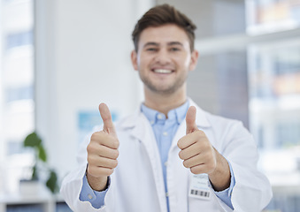 Image showing Medical, thumbs up and portrait of happy doctor with hand gesture or sign excited for good news in a clinic. Young, medicine and man healthcare professional in agreement, thank you and satisfied