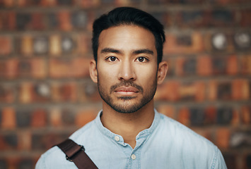 Image showing Serious, confidence and portrait of a businessman in the office standing by a brick wall. Pride, professional and face of an Indian corporate male employee or expert with success in modern workplace.