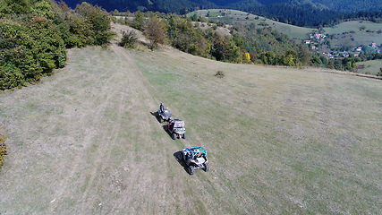 Image showing Aerial drone view of ATV quads on a dirt trail in forests. Off-road group team club enthusiasts having fun while driving countryside roads.