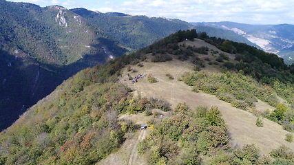 Image showing Aerial drone view of ATV quads on a dirt trail in forests. Off-road group team club enthusiasts having fun while driving countryside roads.