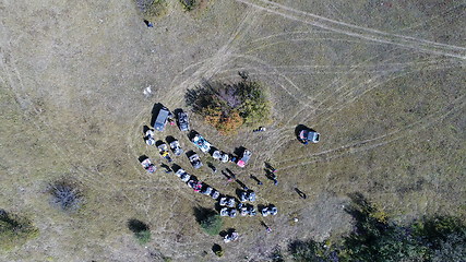 Image showing Aerial drone view of ATV quads on a dirt trail in forests. Off-road group team club enthusiasts having fun while driving countryside roads.