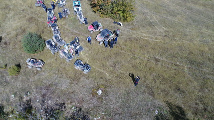 Image showing Aerial drone view of ATV quads on a dirt trail in forests. Off-road group team club enthusiasts having fun while driving countryside roads.