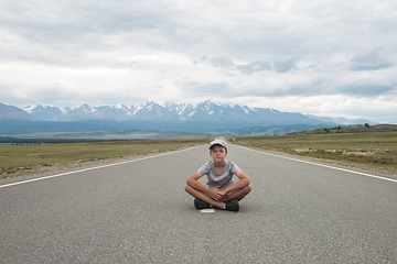 Image showing Young boy sitting on the road