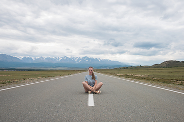 Image showing Woman sitting on the road