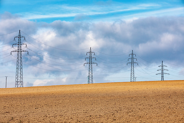 Image showing high voltage power lines against a blue sky