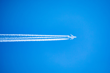 Image showing long trail of jet plane on blue sky