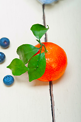 Image showing tangerine and blueberry on white table