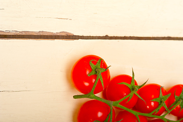 Image showing fresh cherry tomatoes on a cluster