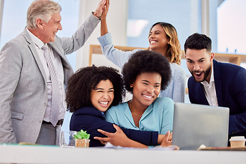 Image showing Business people, hugging and high five in congratulations for promotion, sale or bonus at office desk. Women hug in celebration for corporate success, teamwork or support for winning or achievement