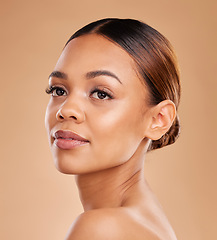 Image showing Beauty, face and a woman in studio for skin glow and shine on brown background. Natural female model with makeup or spa facial, dermatology cosmetics and wellness with self care and skincare