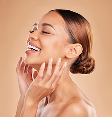 Image showing Smile, beauty and a woman with hands on face for skin care glow and shine in studio on brown background. Aesthetic female model laugh and satisfied with spa facial, dermatology cosmetic and wellness