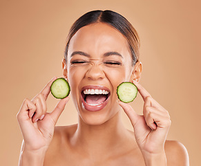 Image showing Skincare, cucumber and face of woman with excited smile for wellness, facial treatment and natural cosmetics. Beauty, spa aesthetic and happy girl with fruit for detox, vitamin c and health in studio