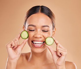 Image showing Beauty, cucumber and face of woman with smile in studio for wellness, facial treatment and natural cosmetics. Skincare, dermatology spa and happy girl with fruit for detox, vitamin c and healthy skin