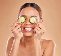 Image showing Skincare, cucumber on eyes and face of woman with smile for wellness, facial treatment and natural cosmetics. Beauty, spa aesthetic and happy girl with vegetable for detox, vitamin c and dermatology