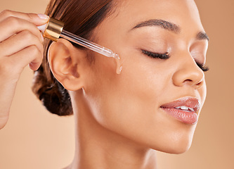 Image showing Beauty serum, oil or girl model in studio on beige background in facial skincare in grooming spa. Face, eyes closed or natural woman with essential oils or glowing luxury self care hydration products