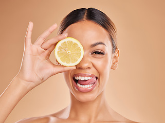 Image showing Lemon, skincare and face of woman with smile in studio for wellness, facial treatment and natural cosmetics. Beauty, spa aesthetic and happy girl with fruit slice for detox, vitamin c and dermatology