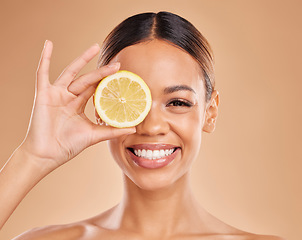 Image showing Skincare, lemon and face of woman with smile in studio for wellness, facial treatment and natural cosmetics. Beauty, dermatology spa and happy girl with citrus fruit for detox, vitamin c and health
