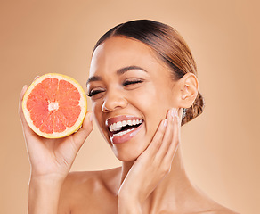 Image showing Skincare, grapefruit and face of woman with smile in studio for wellness, facial treatment and natural cosmetics. Beauty, spa aesthetic and happy girl with fruit for detox, vitamin c and healthy skin