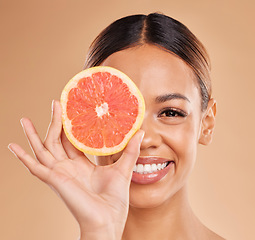 Image showing Skincare, grapefruit and portrait of woman with smile in studio for wellness, facial treatment and natural cosmetics. Beauty, spa and happy girl with fruit slice for detox, vitamin c and dermatology