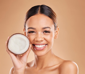 Image showing Skincare, coconut and portrait of woman with smile for wellness, facial treatment and natural cosmetics. Beauty, dermatology spa and happy girl with fruit for detox, organic and nutrients in studio