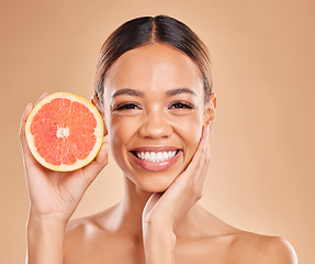 Image showing Skincare, grapefruit and face of woman with smile in studio for wellness, facial treatment and natural cosmetics. Beauty, spa aesthetic and happy girl with fruit for detox, vitamin c and healthy skin