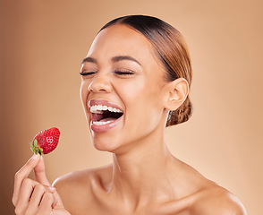 Image showing Beauty, skincare or funny woman with strawberry in studio on beige background for healthy nutrition or clean diet. Smile, happy or girl model laughing with natural fruits for nutrition or wellness