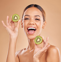 Image showing Skincare, kiwi and portrait of woman with smile in studio for wellness, facial treatment and natural cosmetics. Beauty, organic spa and happy girl with fruit for detox, nutrients and healthy skin