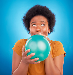 Image showing Balloon, happy and black woman in studio for celebration, good news or birthday on blue background. Party, blowing and girl with inflatable while celebrating, excited and having fun while isolated