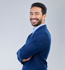 Image showing Business man, arms crossed and smile portrait in studio for corporate or CEO fashion while happy. Face of asian entrepreneur person on isolated white background with pride for career and success