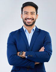 Image showing Business man, smile and arms crossed portrait in studio for corporate or CEO fashion while happy. Face of asian entrepreneur person isolated white background with pride for luxury, success and wealth