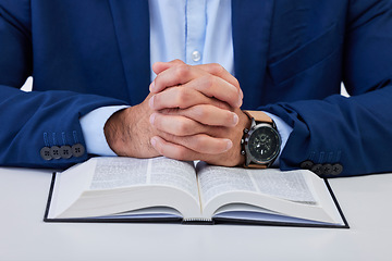 Image showing Closeup, hands and man with bible, praying and guidance with higher power, hope and spiritual. Zoom, male and Christian with holy book, scripture and religious with faith, Catholic text and belief