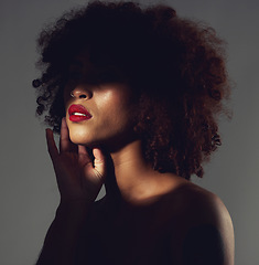 Image showing Makeup, red lipstick and shadow of black woman with beauty, afro or natural hair in studio. Face of aesthetic female model with a skin glow, shine and color on lips for art, power and facial skincare